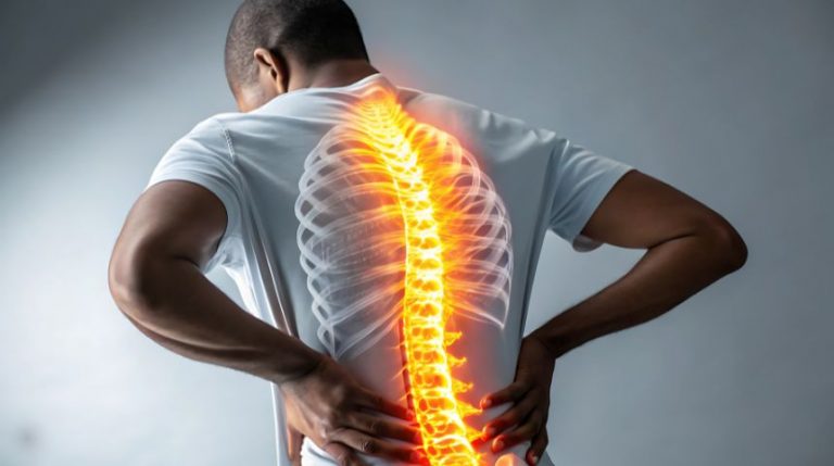 A digital image showing a man's spine in bright orange through his back.